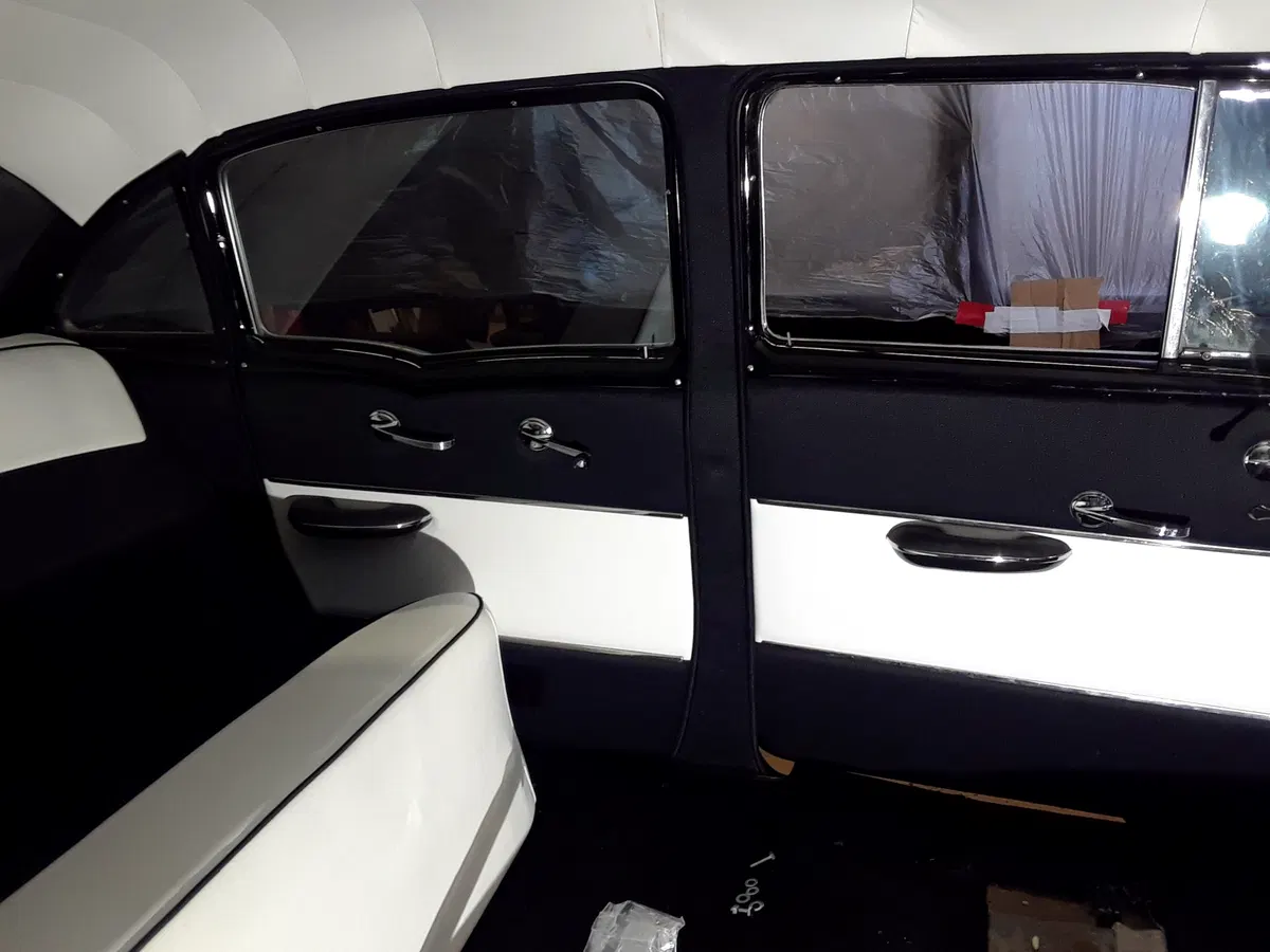 Black-and-white customized interior of a vintage Chevrolet Bel Air with matching upholstered doors