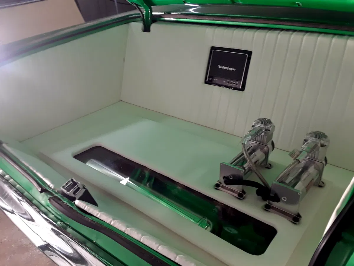 Mint-green upholstered lowrider trunk with custom integrated trim details