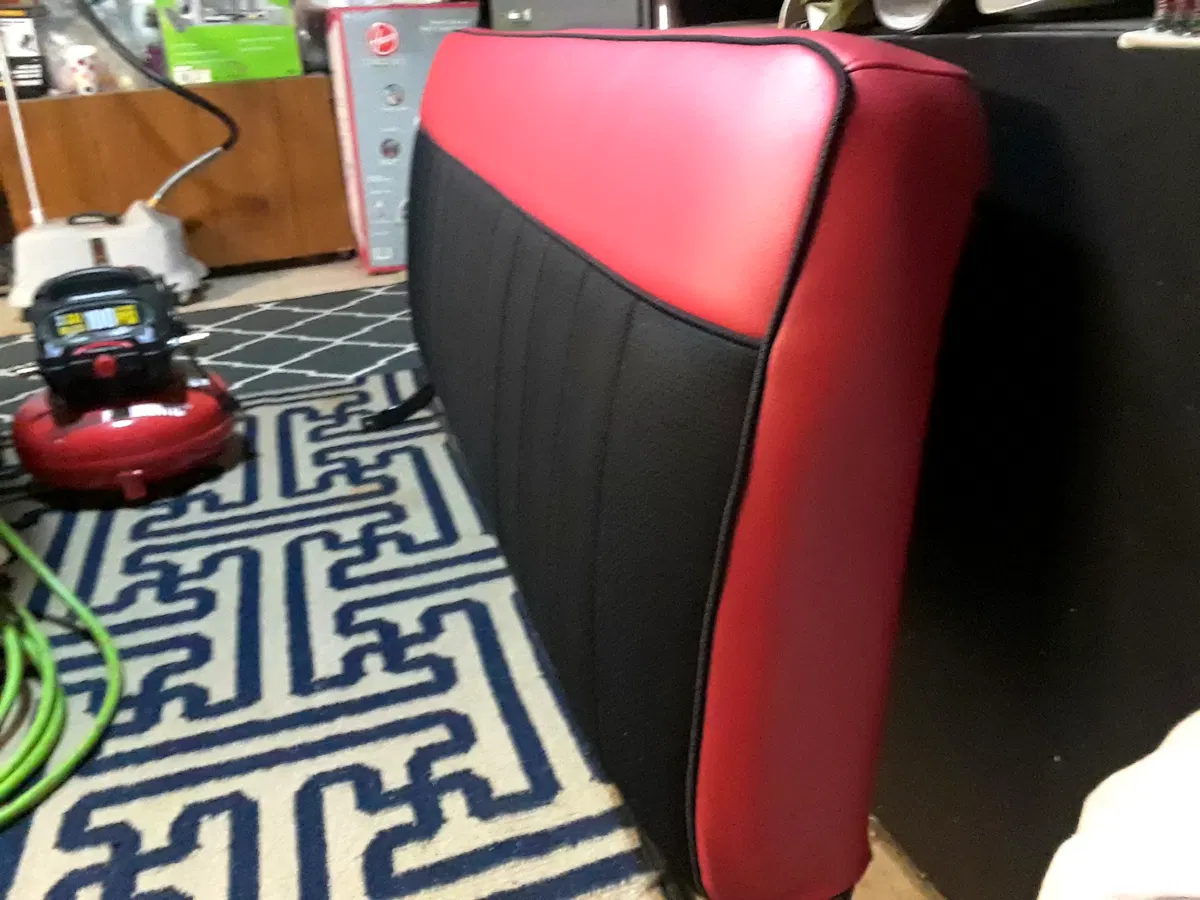 Custom red and black automotive vinyl bench seat side panel detail