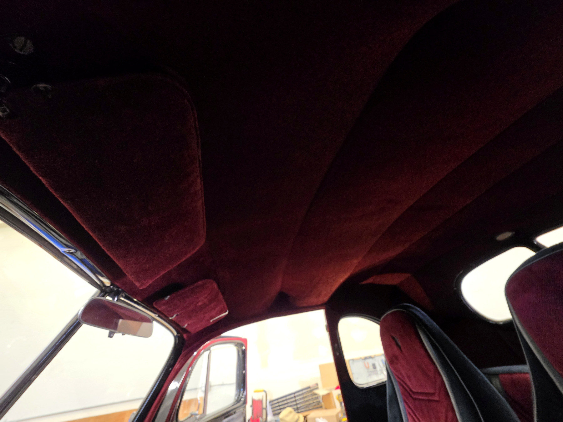 Custom burgundy automotive headliner installed inside a classic car