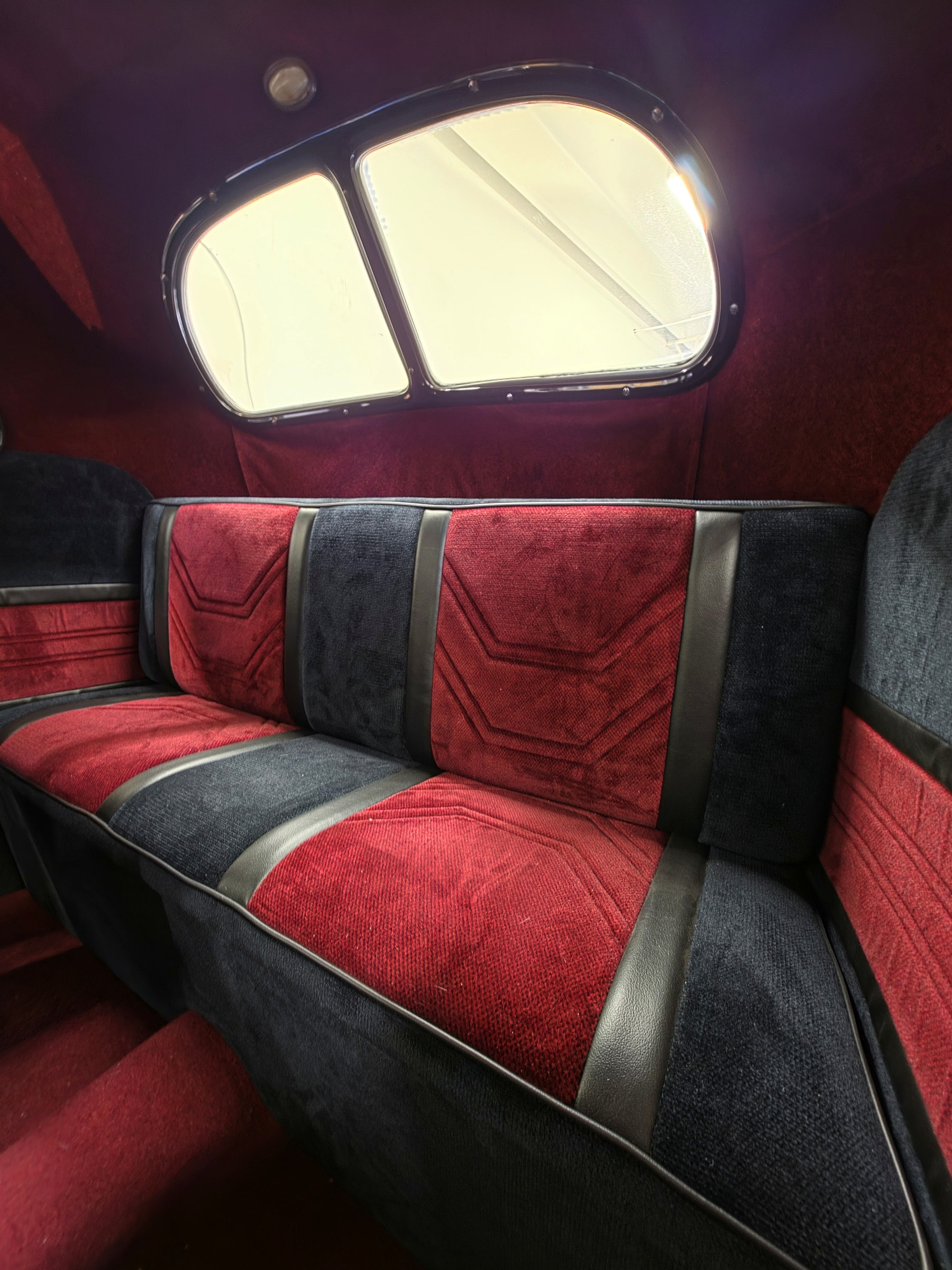 Red and black custom rear bench seating upholstered for a classic car by Fine Line Auto Trim